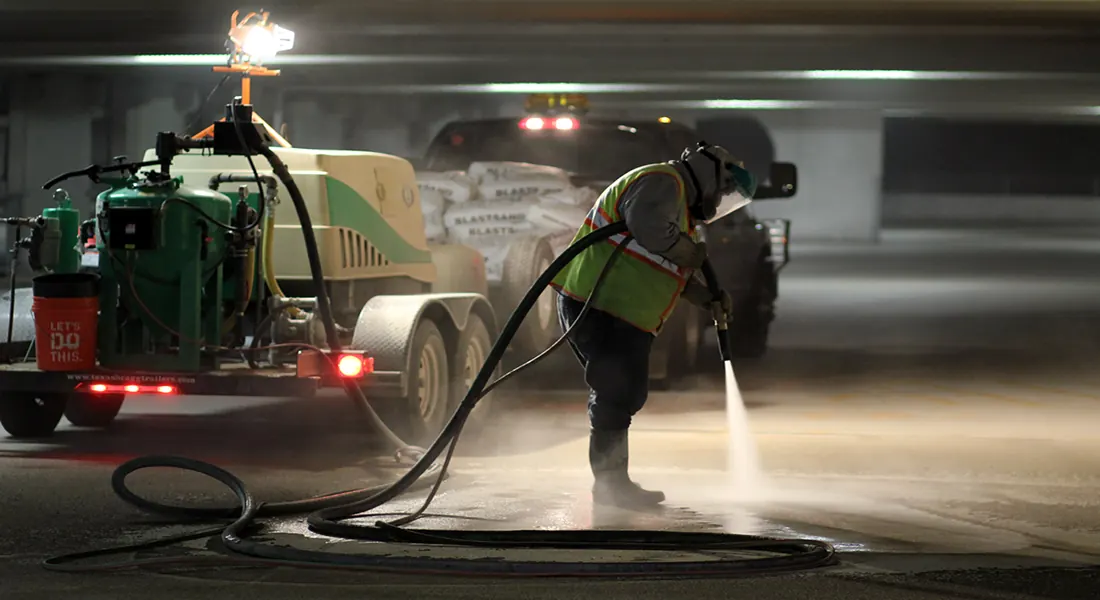 Conventional abrasive blasting across a large flat surface